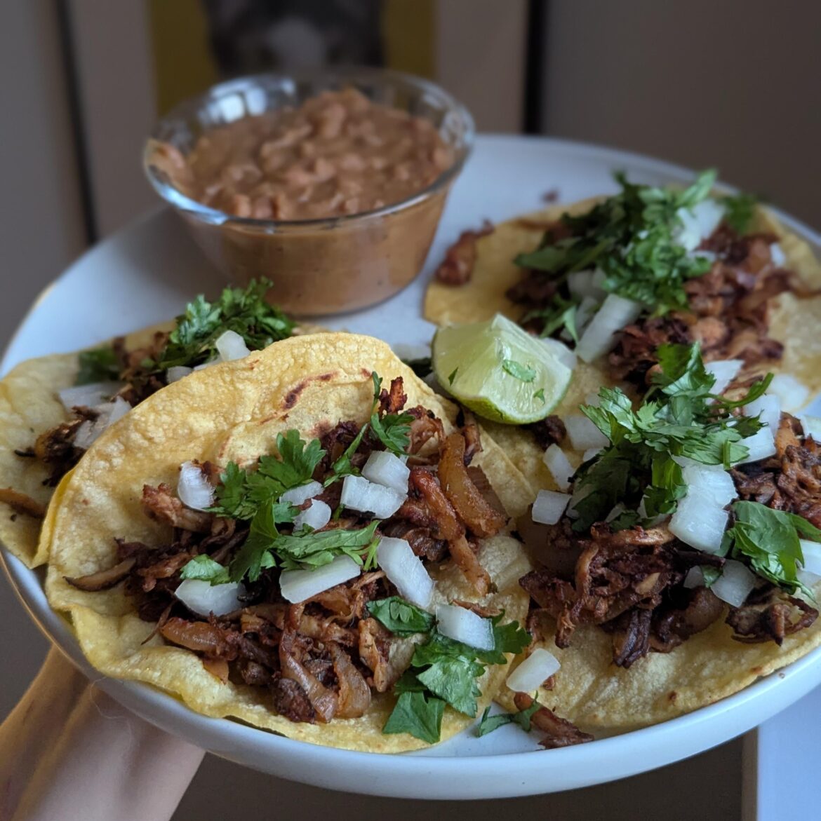 Trumpet mushroom carnitas tacos and refried beans.