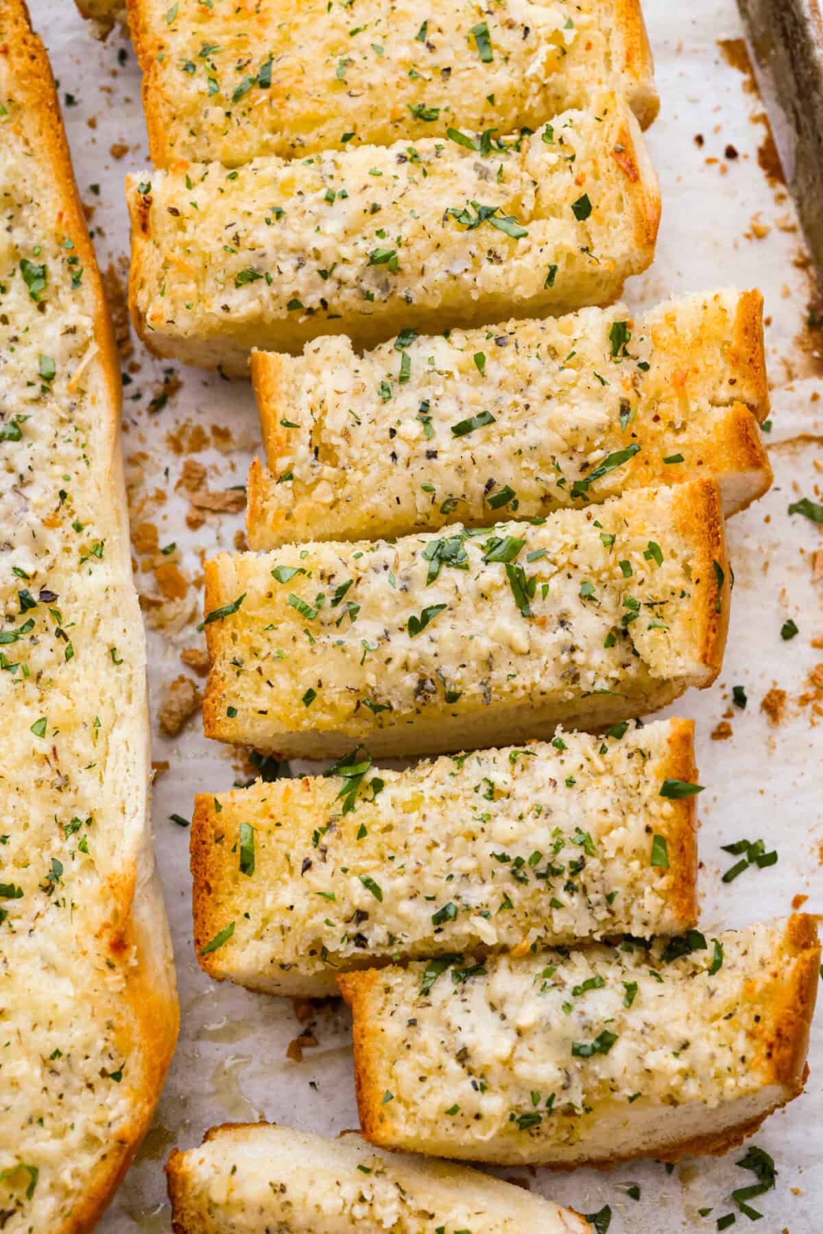 I’m not saying I’ve eaten half a loaf of this Garlic Bread straight off the baking sheet…but I’m also not not saying that. It’s golden, cheesy, dripping with garlicky butter, and so good! Slice up browned garlic bread.