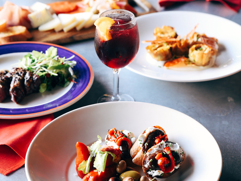 Plated food and a drink in a wine glass at La Bodega in Kansas City