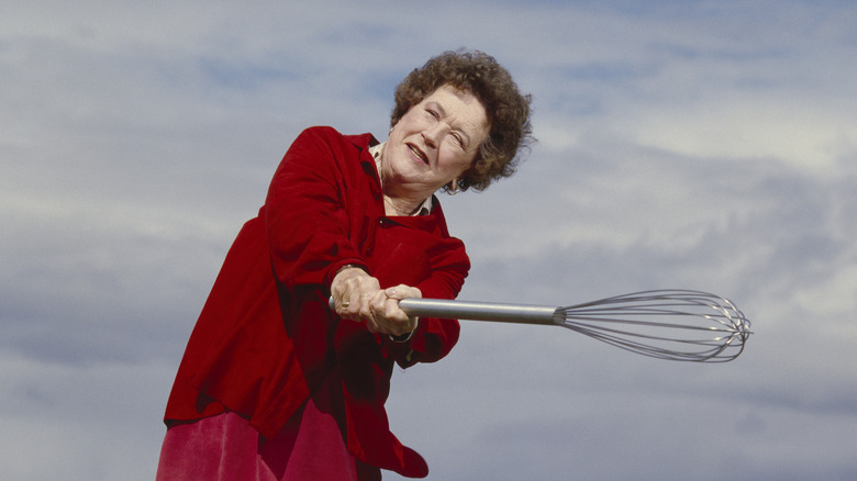 Chef Julia Child swinging a whisk like a baseball bat
