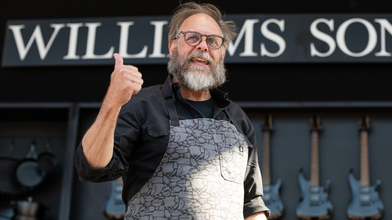 Alton Brown gives thumbs up with glasses and beard