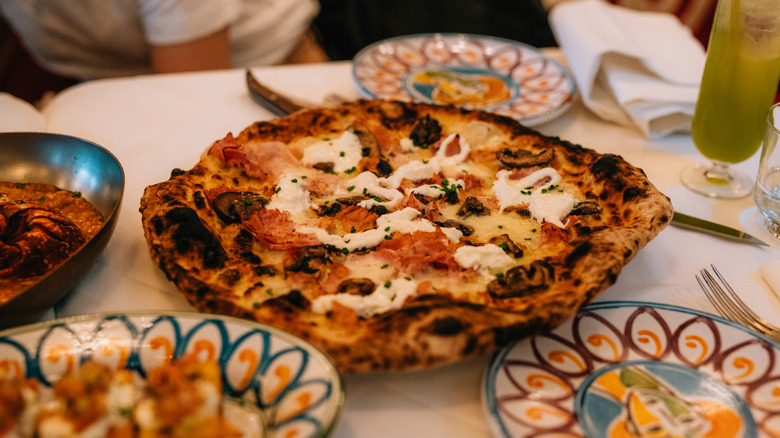 A fancy looking pizza on a restaurant table