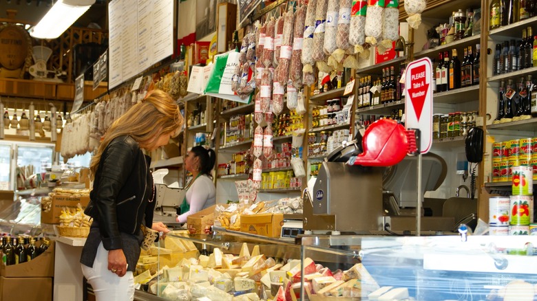 Woman ordering meat and cheese at an Italian deli counter