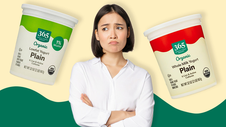 A person frowning with two whole foods yogurts