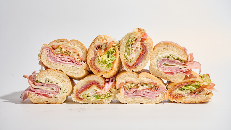 Sliced Italian subs stacked on a white table