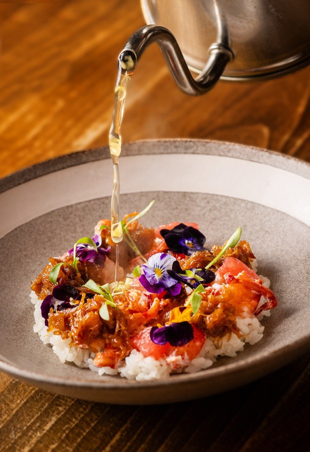 Lobster XO with a table side pour of shiitake lemongrass tea over sushi rice from the Golden Bear Station Thursday, January 11, 2023 on Highway 12 in Kenwood. (John Burgess / The Press Democrat)
