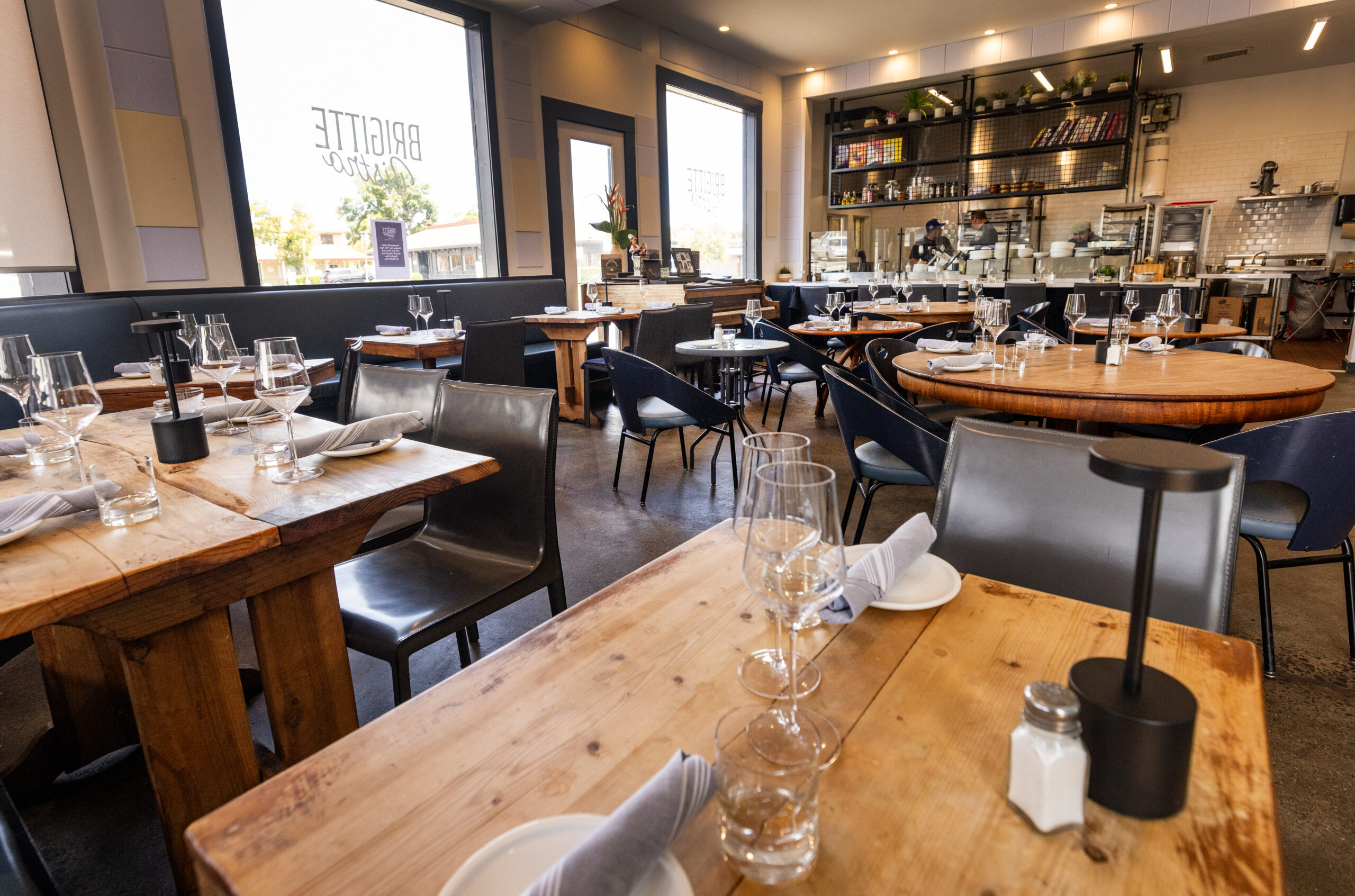 The Brigitte Bistro dining room features tables of different heights and dimensions because “Everybody’s different,” says Chef Nick Ronan Sunday, July 6, 2025 in Petaluma. (John Burgess / The Press Democrat)