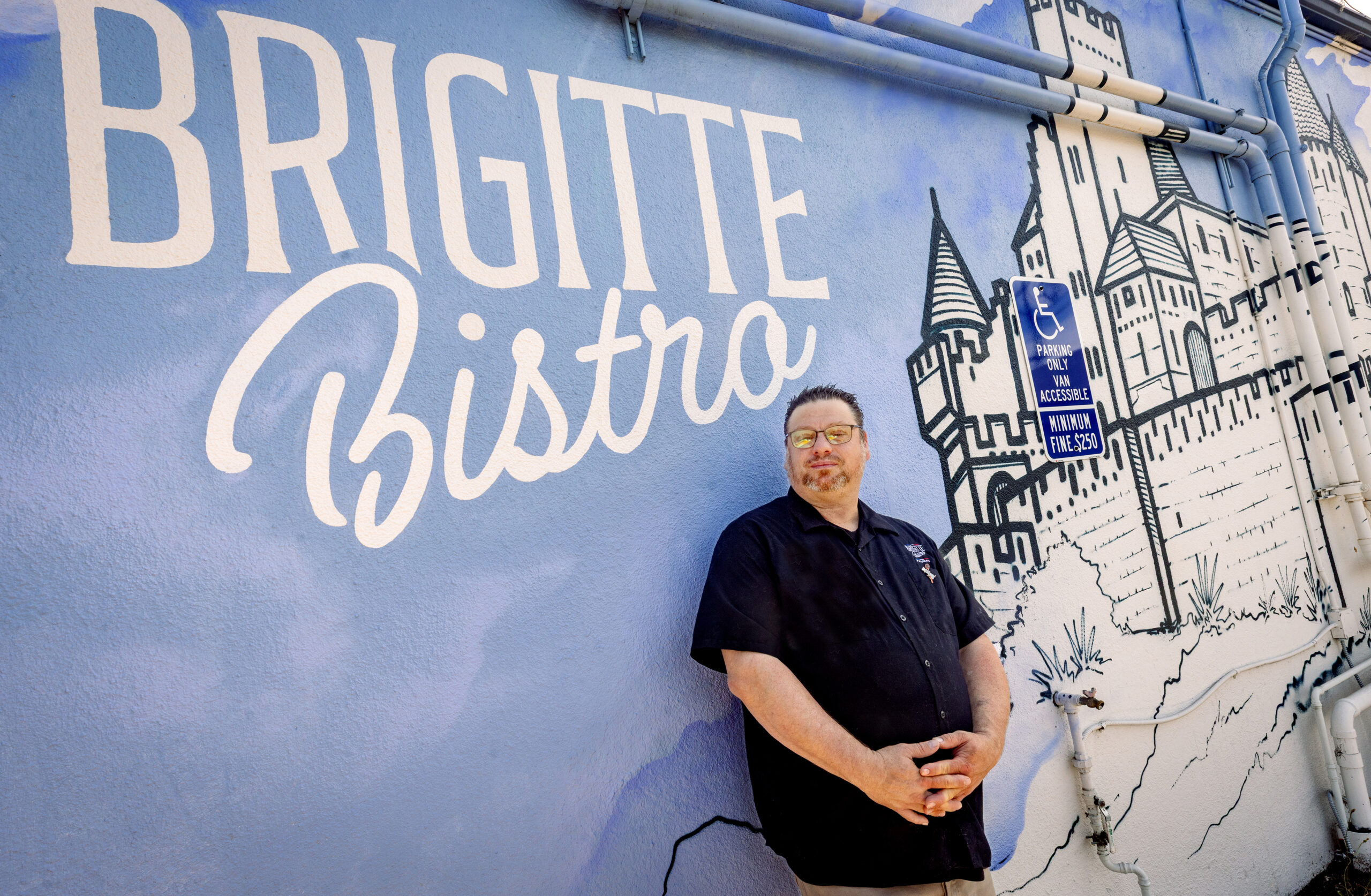 Chef Nick Ronan chose to add a mural of his hometown in southern France to the wall outside Brigitte Bistro Sunday, July 6, 2025, in Petaluma. (John Burgess / The Press Democrat)