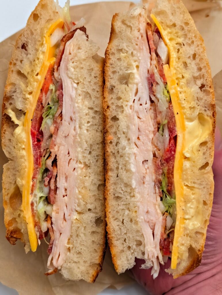 Today's lunch: turkey, bacon, cheddar, lettuce, tomato, onion with mayo and Dijon mustard on sourdough focaccia