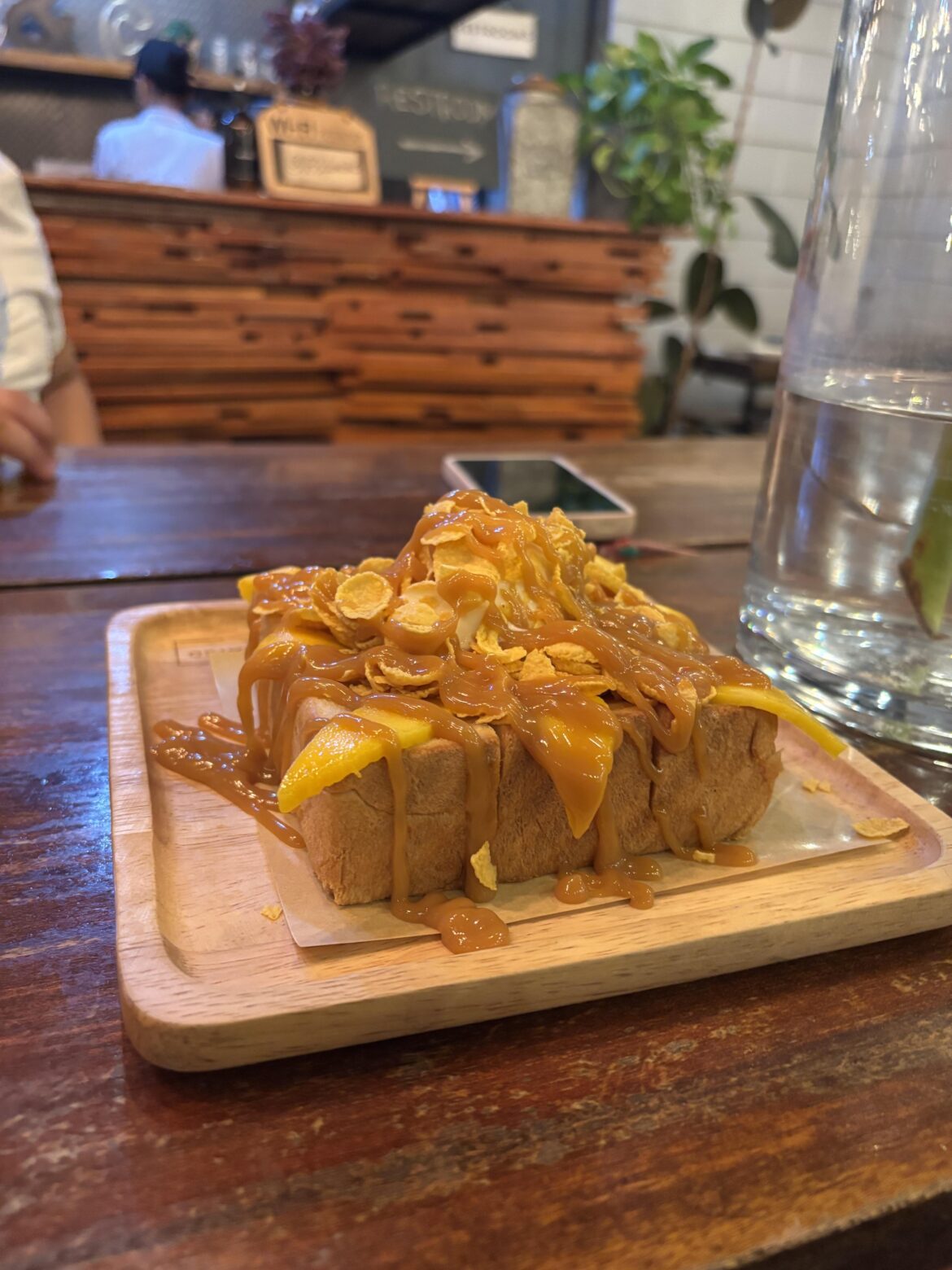 It’s toasted loaf bread topped with ice cream, mango, caramel syrup and cornflakes