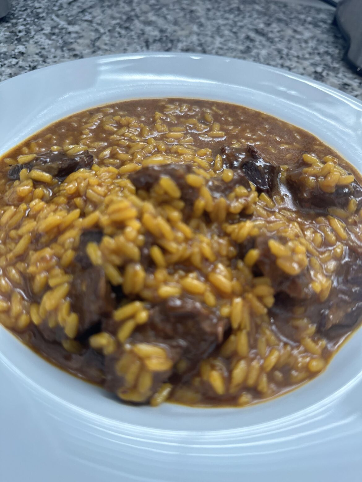 Homemade creamy rice with beef and pedro ximenez (arroz meloso con carne y pedro ximenez)