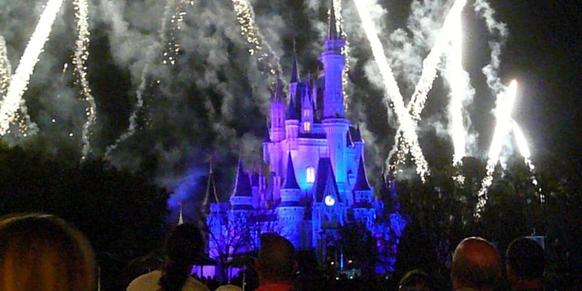 People watching fireworks over Cinderella Castle at Magic Kingdom Park.