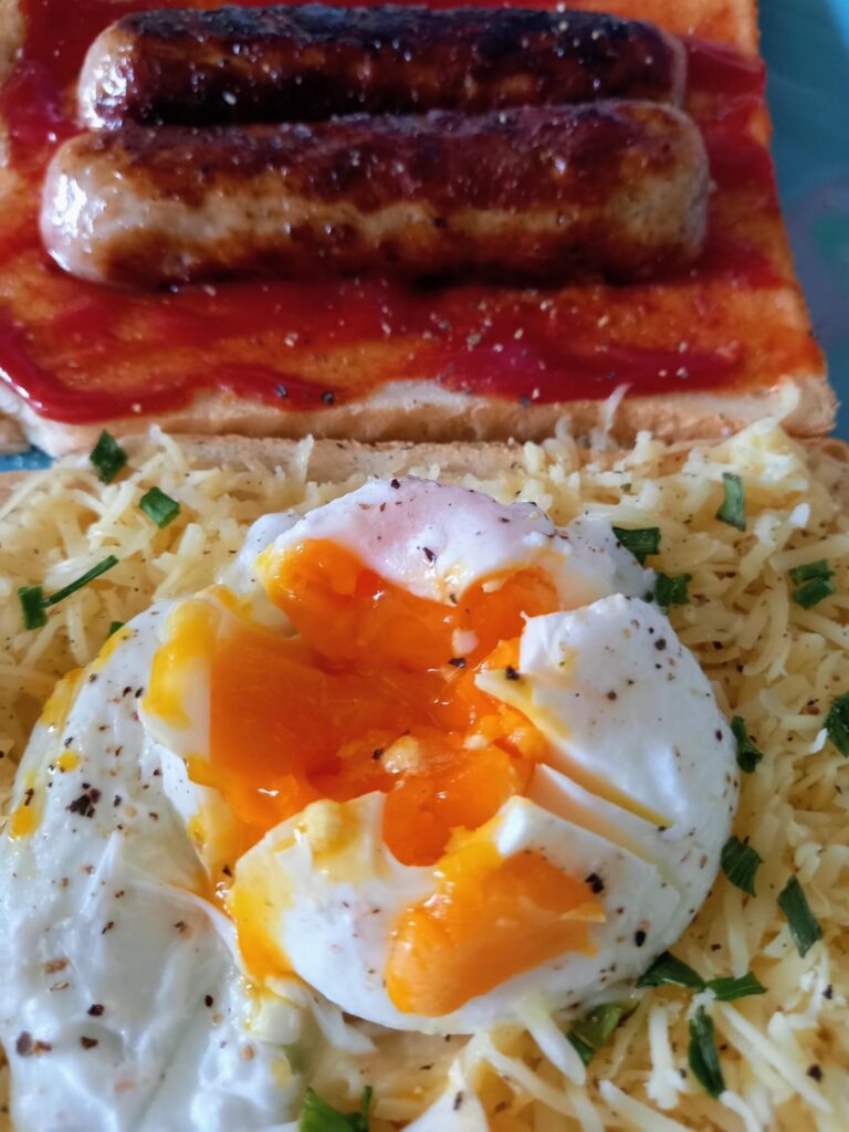 Simple Pork Chipolatas & Poached Egg Sarnie, Extra Mature Cheddar, Chives, Pink Himalayan Sea Salt & Mixed Peppercorns