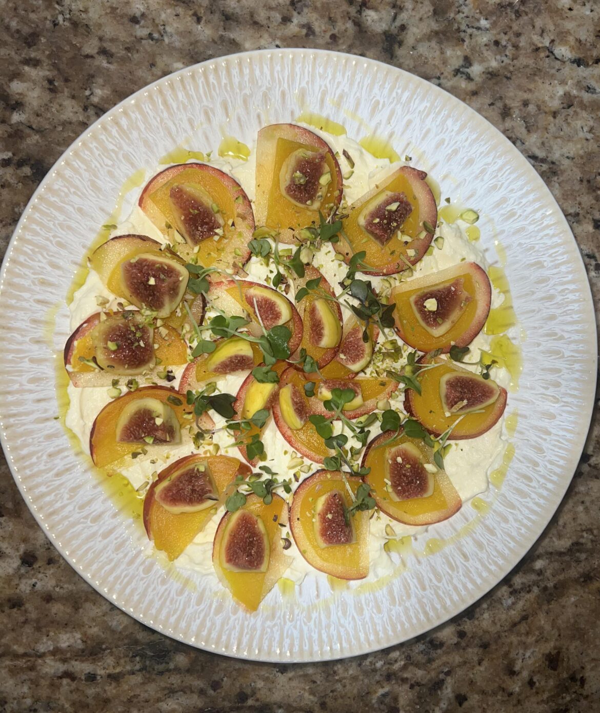 Figs, golden beetroot and peaches on whipped ricotta with Pistachio and microgreens