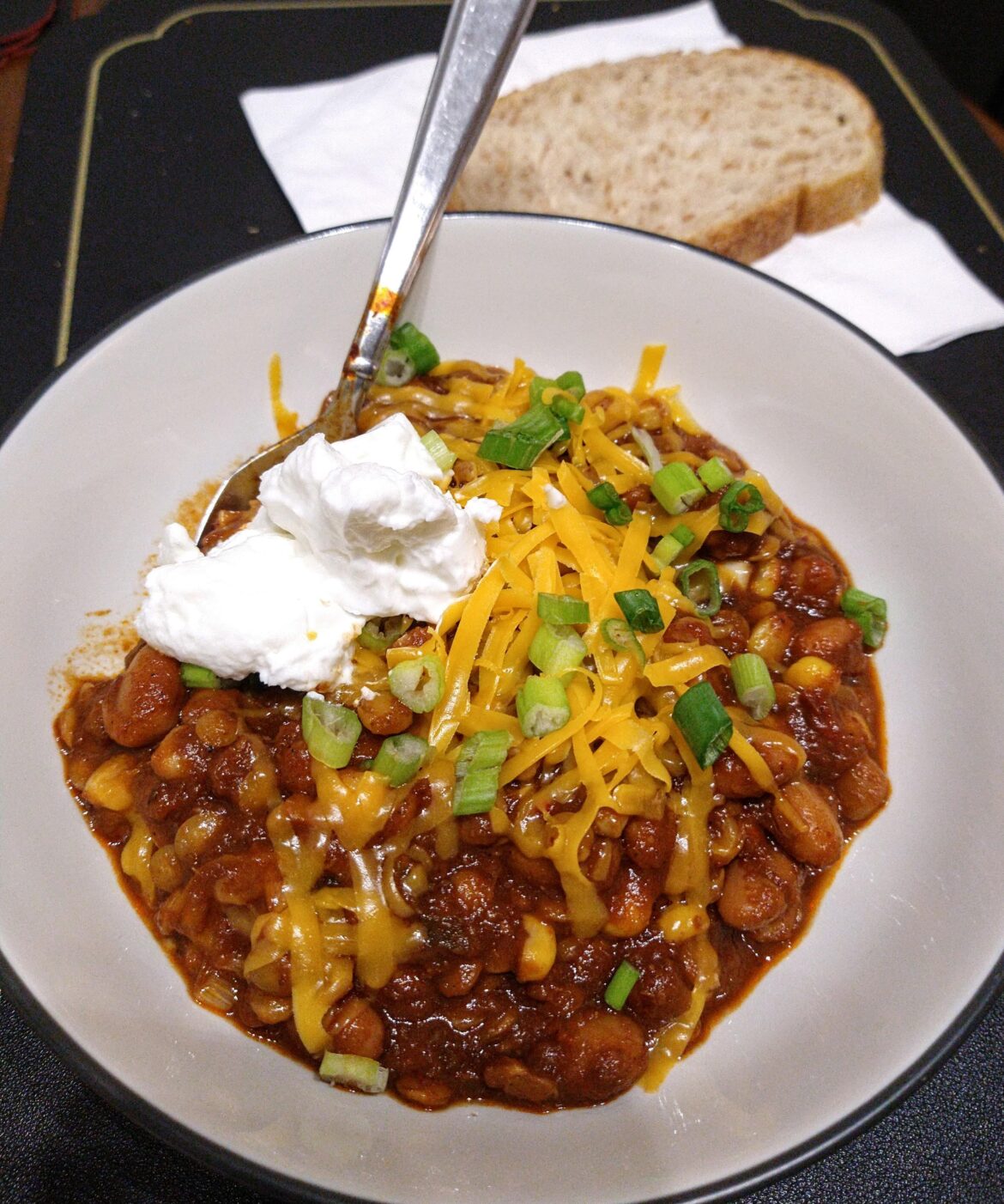 Bean and lentil chili with toppings