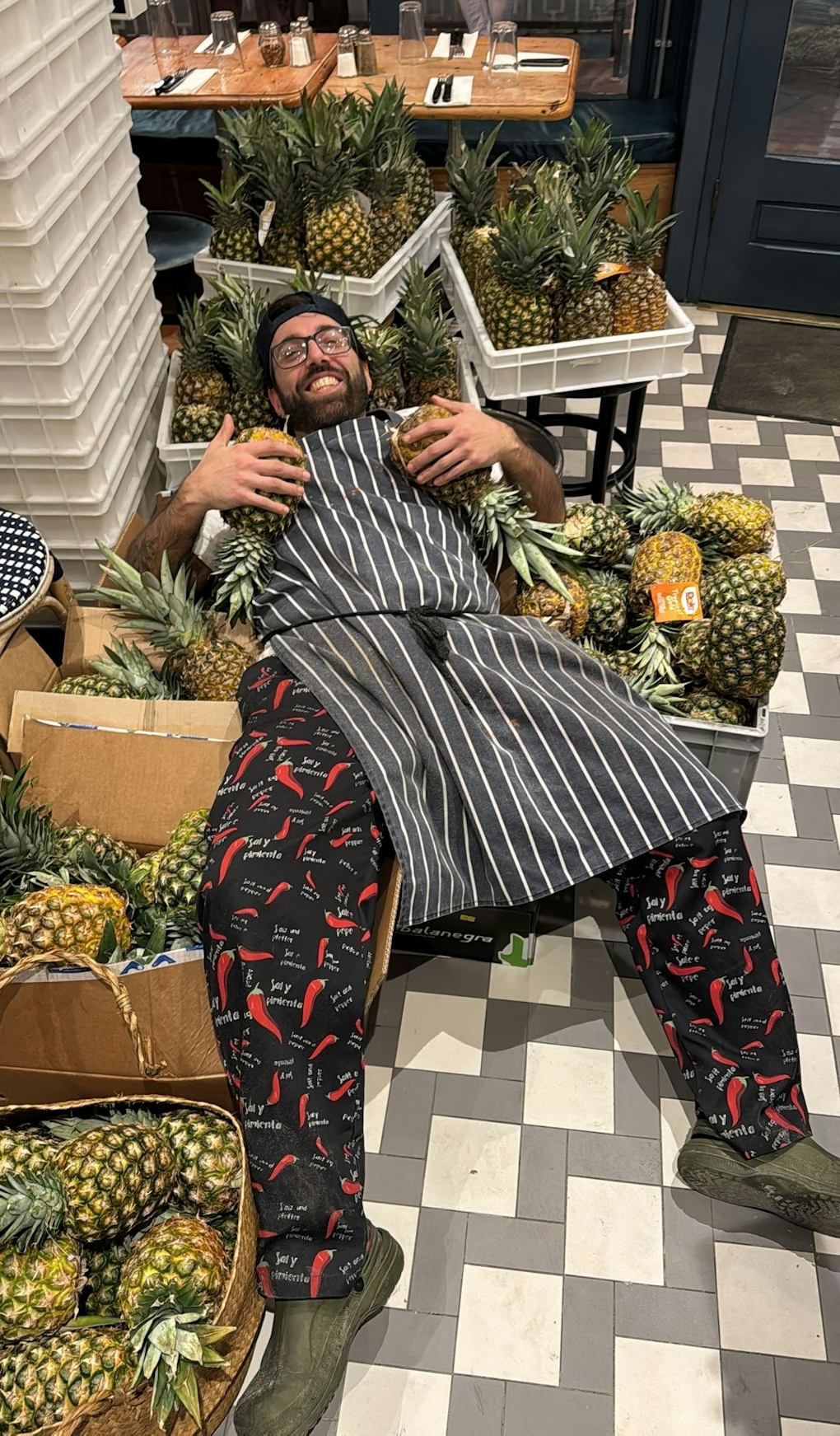 A member of the Fatto a Mano team surrounded by pineapples A member of the Fatto a Mano team surrounded by pineapples