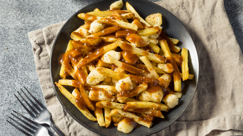Poutine on plate on tea towel