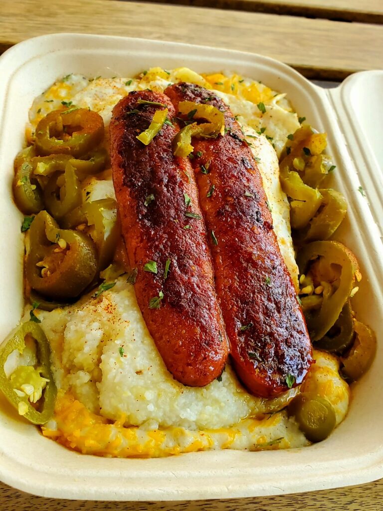 Hot Mess Bitch - biscuit and gravy smothered in cheese, grilled Louisiana hot link, 2 eggs, garlic grits and jalapeños