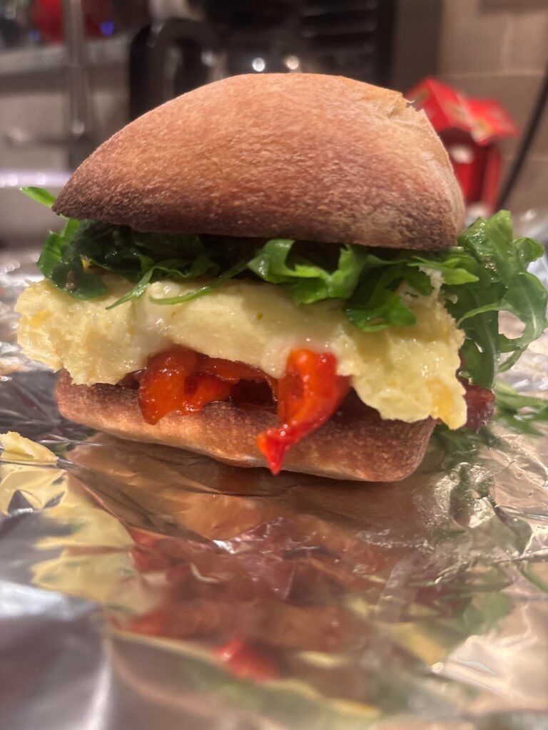Sweet Italian sausage, roasted red pepper, provolone, egg, and lemon’d arugula on ciabatta.