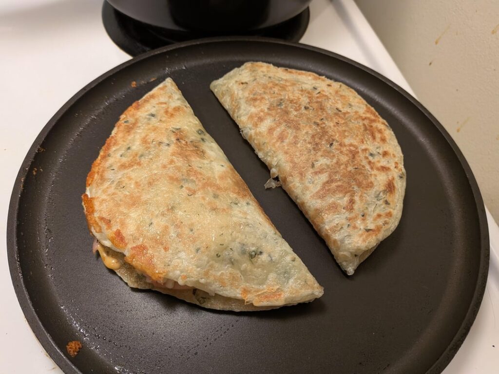 Ham Eggs and Cheese flatbread (Flaky Paratha) sandwiches.