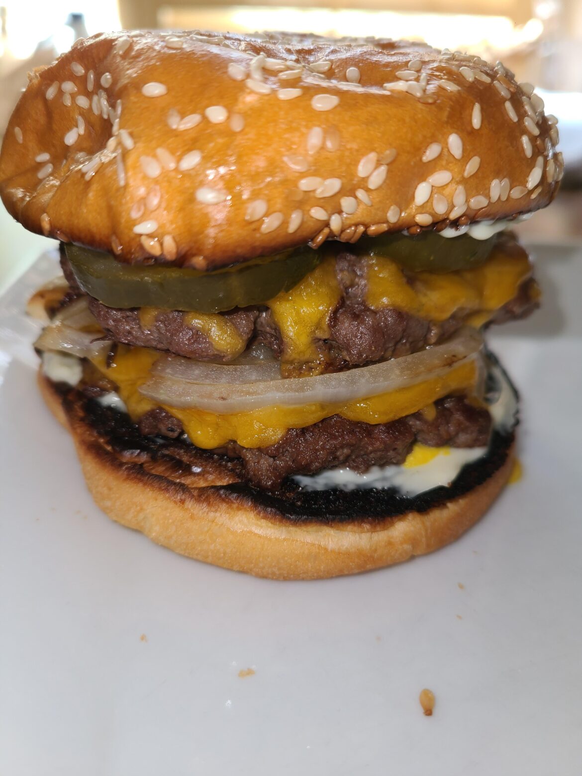 Double with cheddar, grilled onion, sweet pickles, mayo, and mustard on a toasted bun