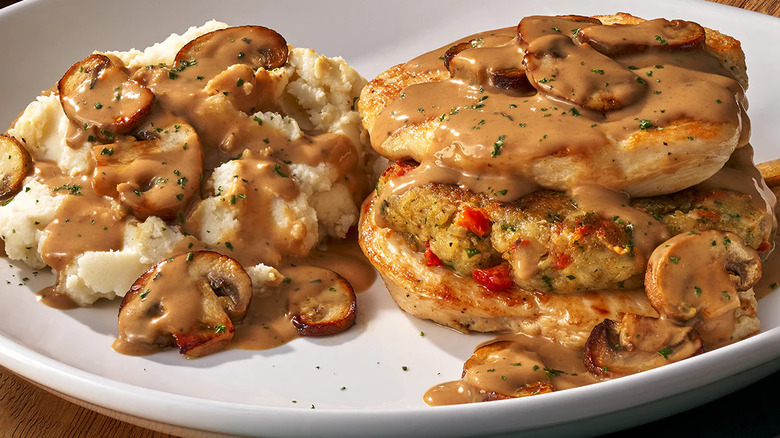 Stuffed chicken marsala plated in a white dish