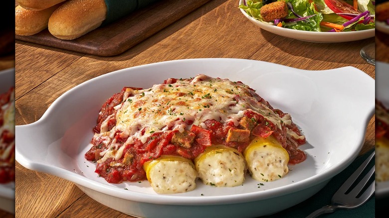 Three-meat manicotti plated in a white dish