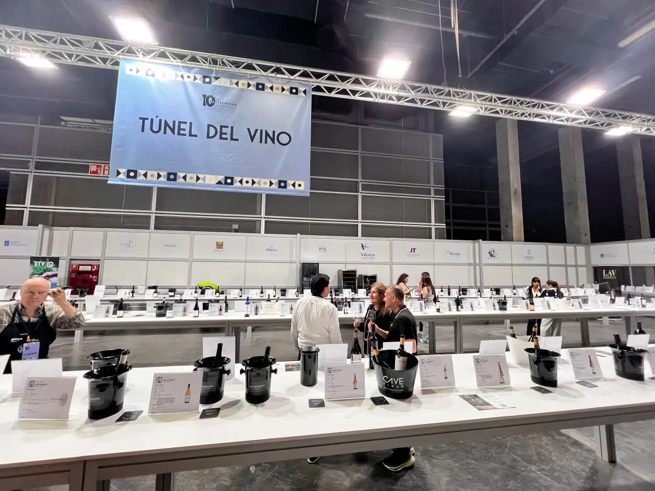 Visitors tasting wines at the Túnel del Vino section during Gastrónoma 2025 in Valencia