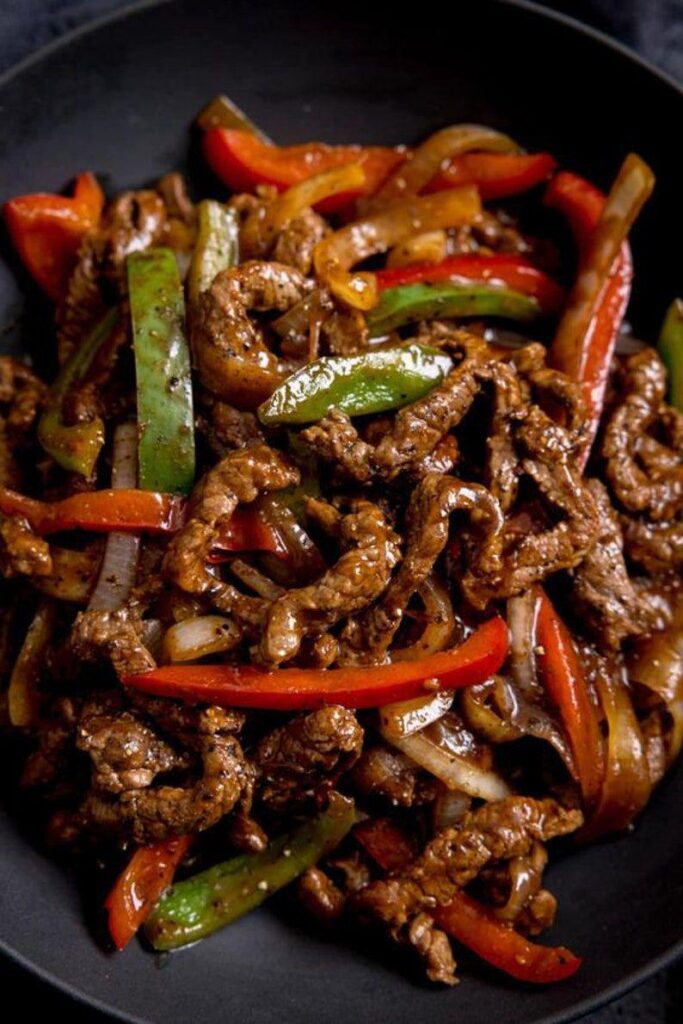 Pepper steak stir-fry loaded with tender beef, crisp bell peppers, and onions in a rich, savory sauce.