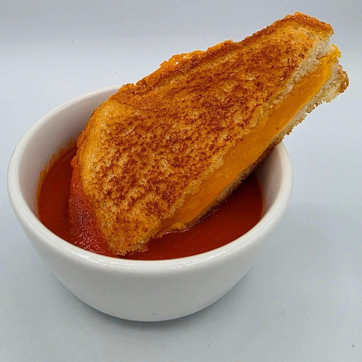 I love a rainy night. Sourdough, American cheese, sharp cheddar, and butter in bone broth and miso tomato soup.