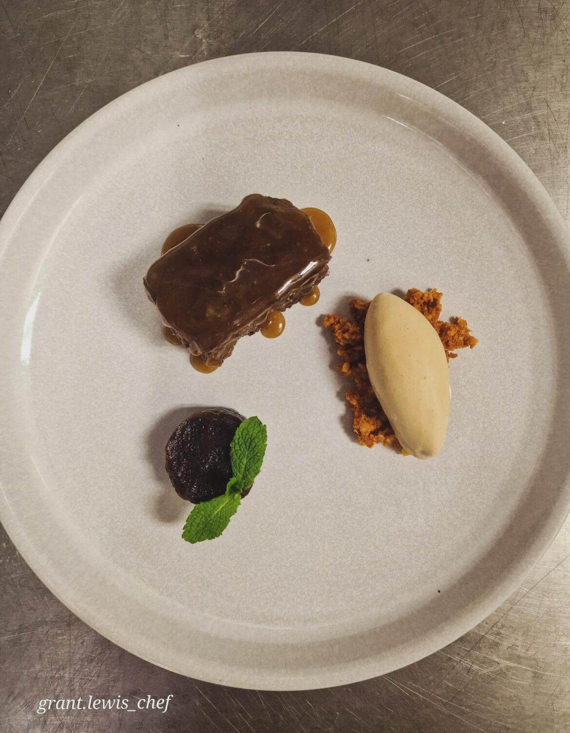 Sticky toffee with caramel sauce, date jam, and salted caramel ice cream, served on honeycomb crumb.