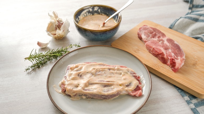 Raw loins of pork marinating in yogurt blend