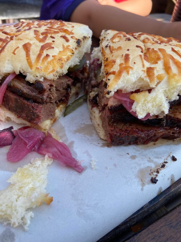 Lunch at the best smokehouse in southern Buenos Aires. Brisket sandwich on Parmesan bread with mayo, onions and pickles.