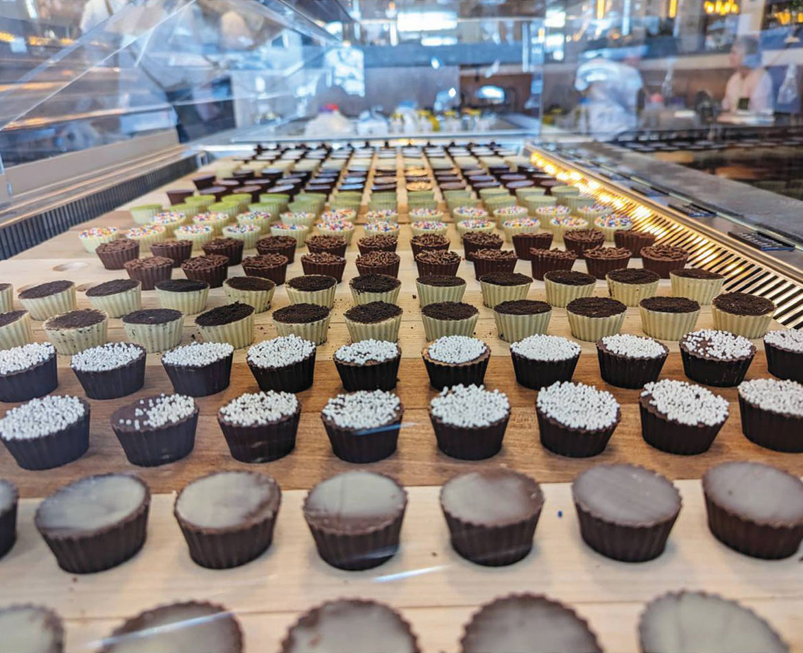 An army of chocolate cups on display.