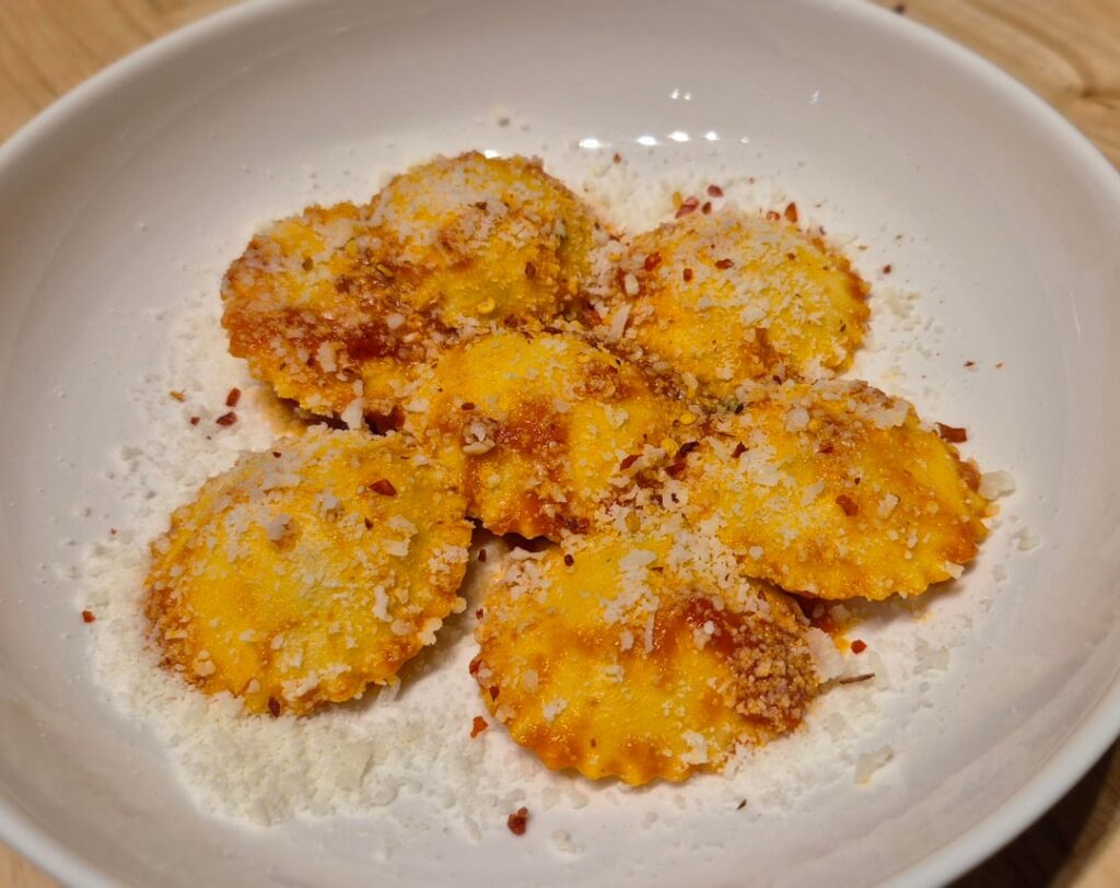 Four Cheese Ravioli in a light Tomato Sauce with Pecorino Romano and Smoked Calabrian Chili Flakes