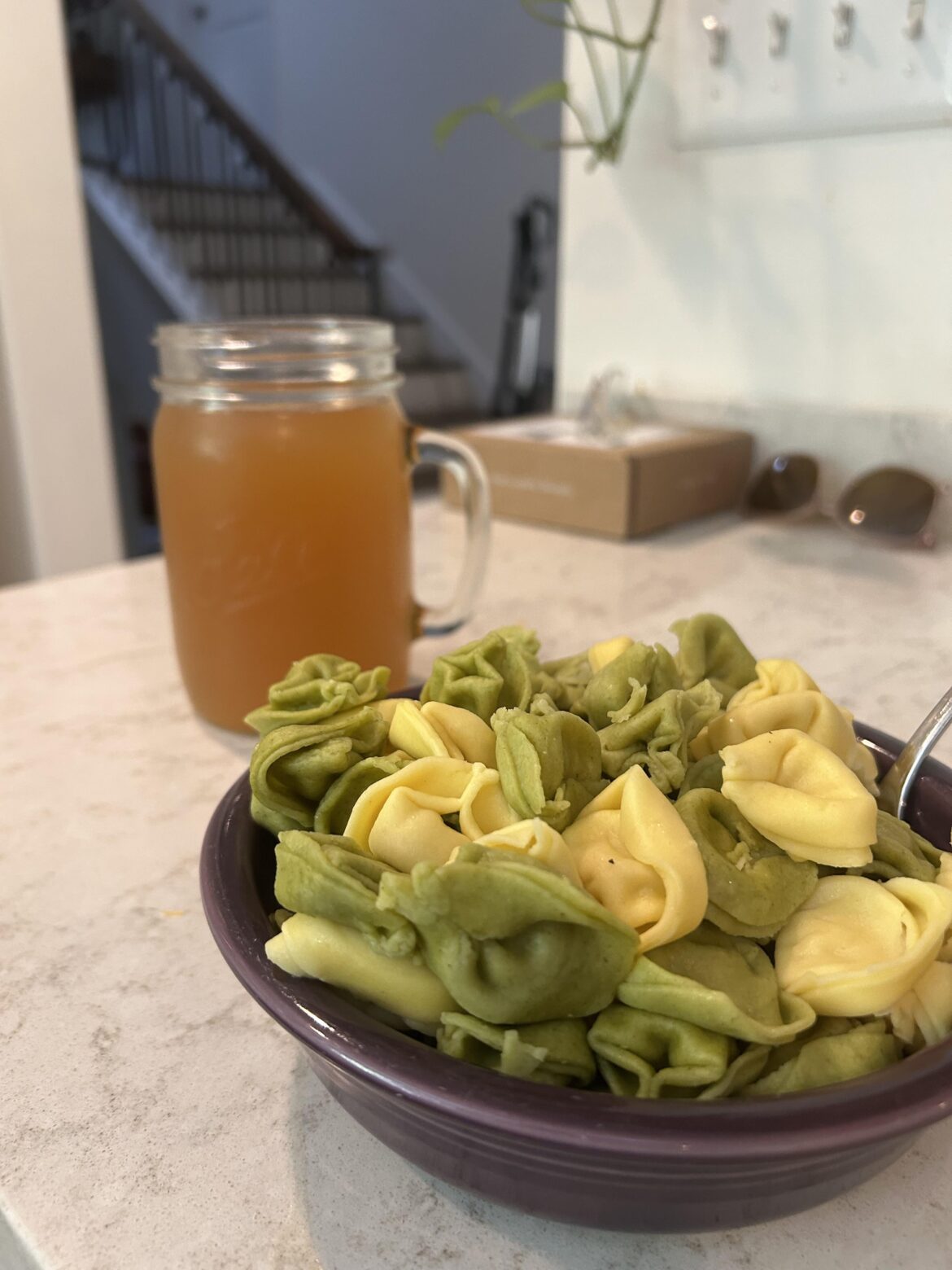 tortellini with no sauce and jar of apple cider