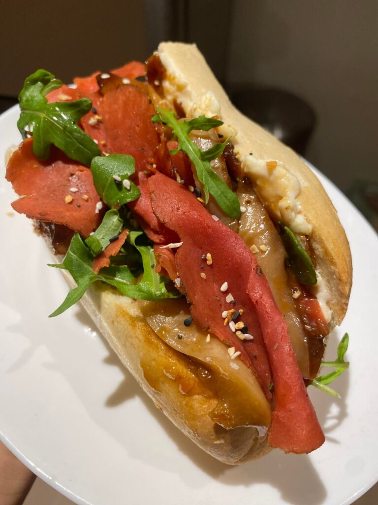 Roast beef with rocket, caramelised peaches, red onion chutney and burrata on baguette