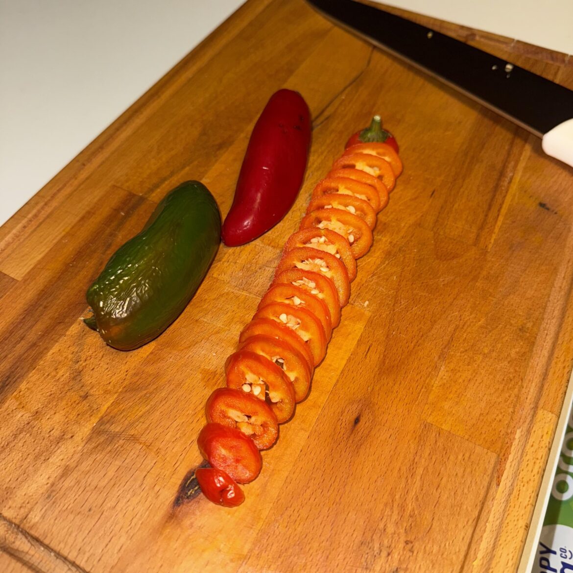 Holy trinity of jalapeños. Red, green, and orange.