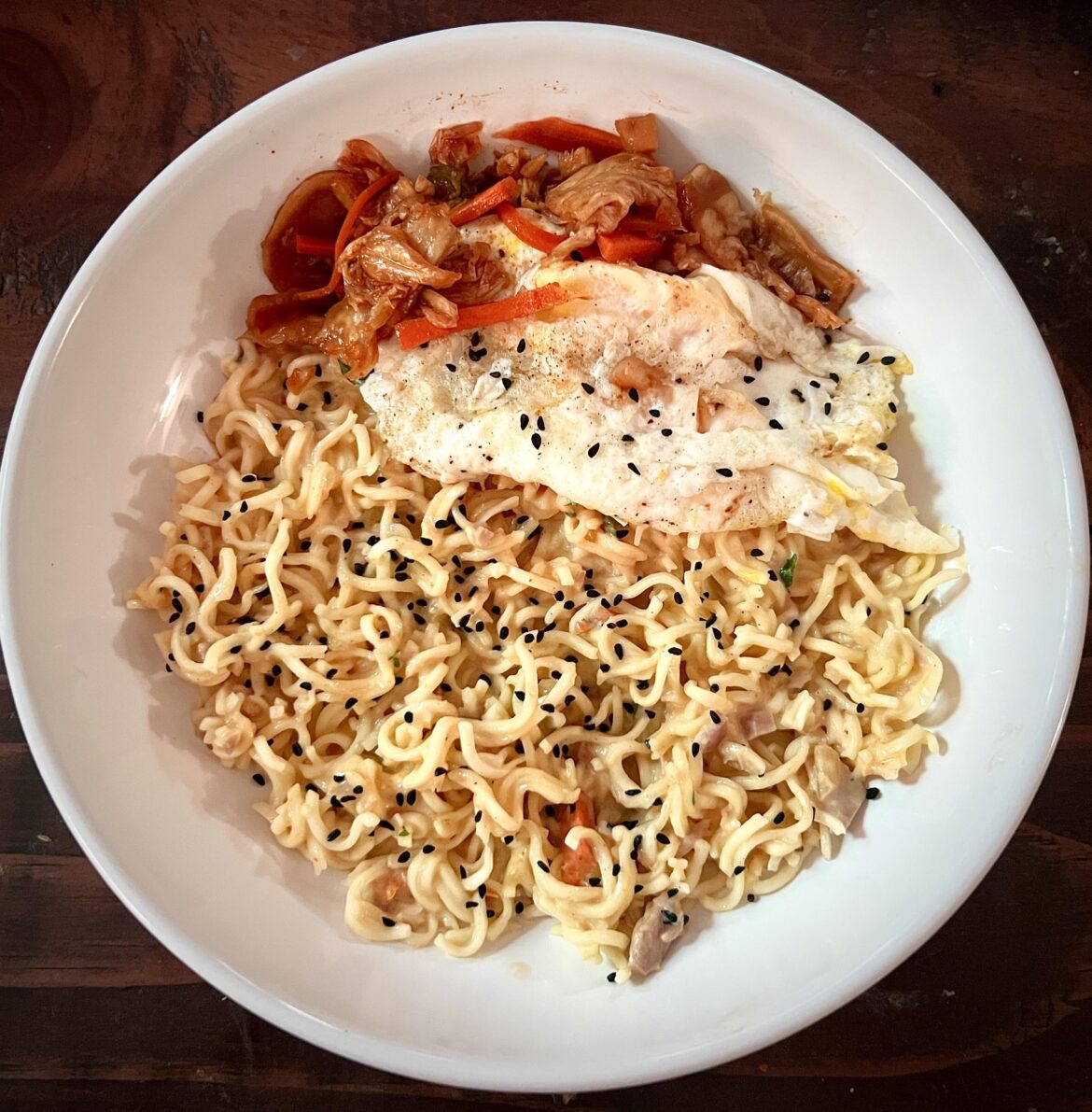 Spicy kimchi tuna & cheesy ramen noodles topped with fried egg & more spicy kimchi