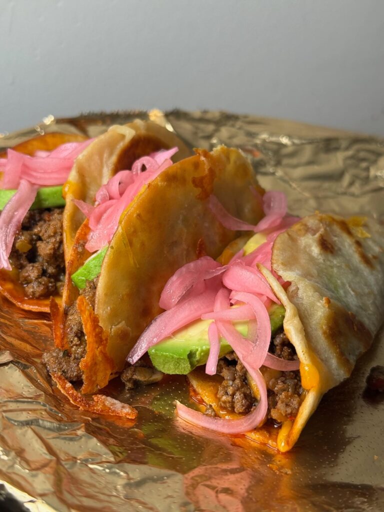 Fried flour torts, smoked cheddar, gringo ground, avo, pickled red onions.