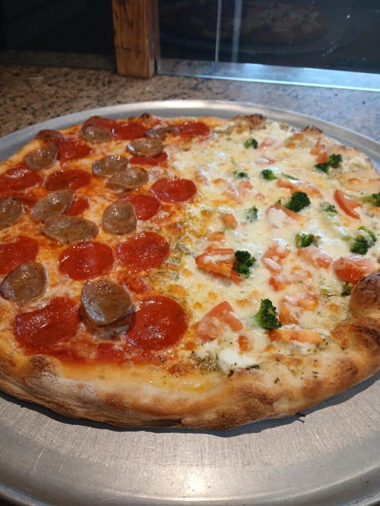 half pepperoni and sausage and half white with tomato and broccoli