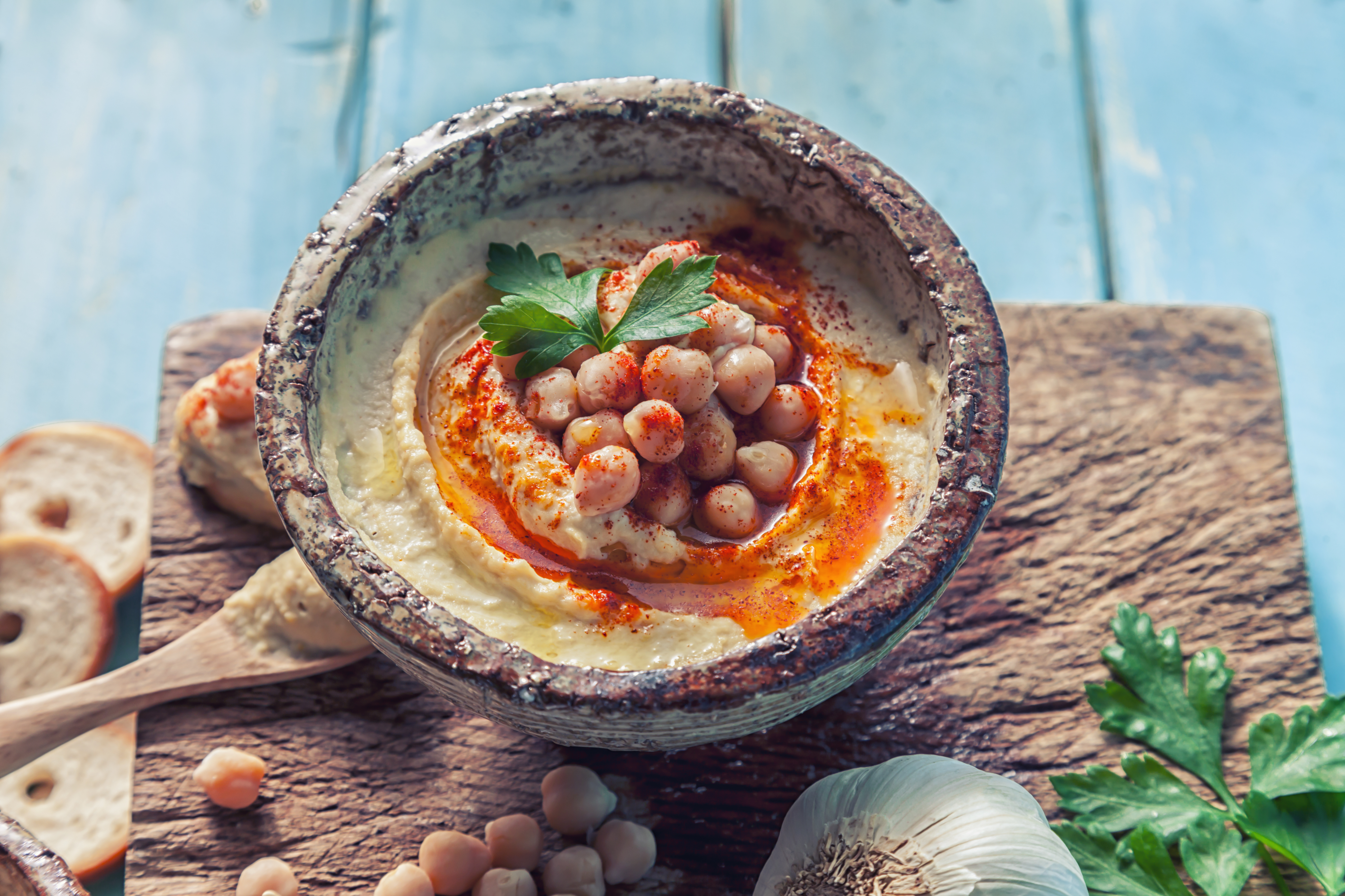 Hummus topped with whole chickpeas and olive oil.