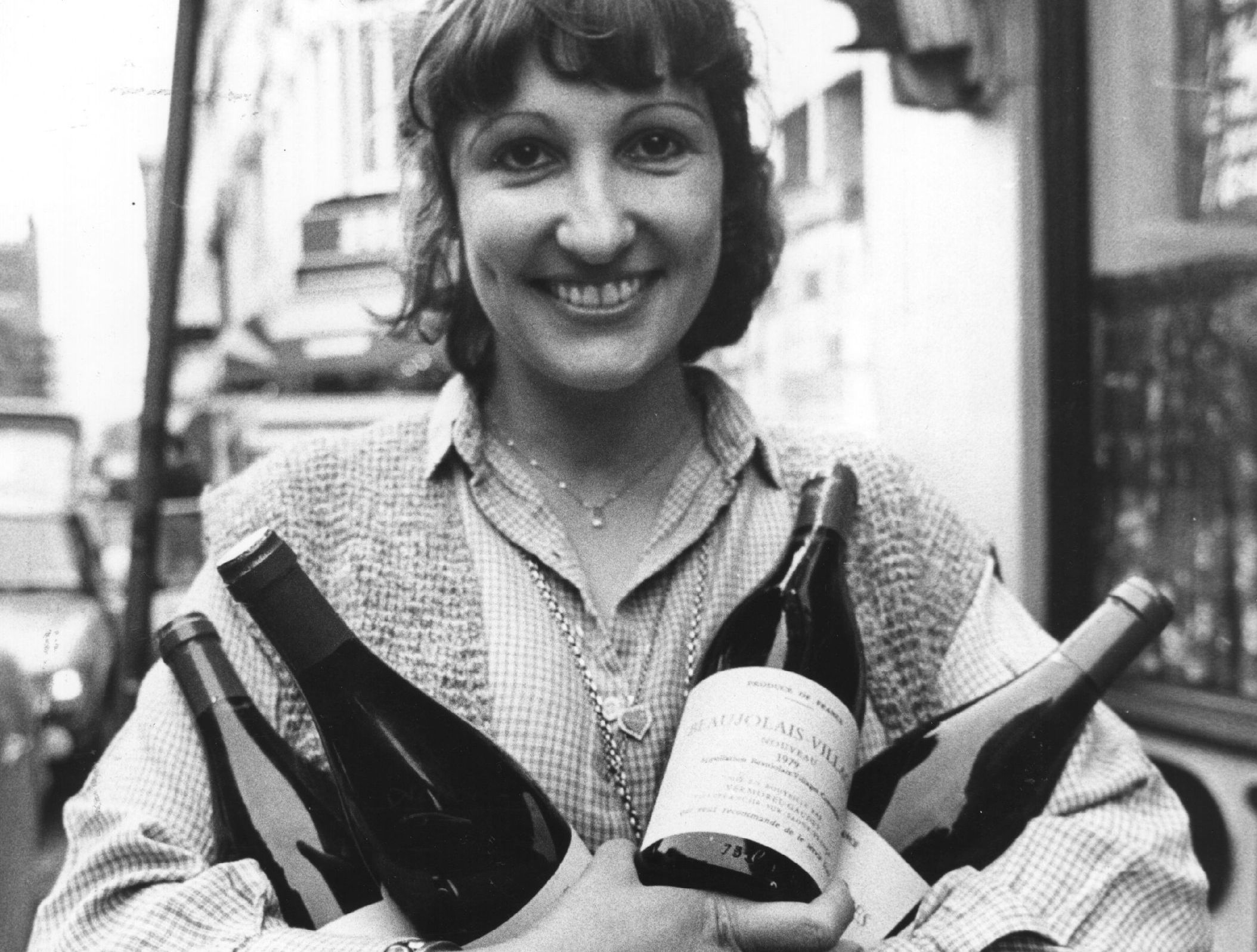 Judy Bray, owner of Bray's Wine Bar, holds several bottles of Beaujolais Nouveau.