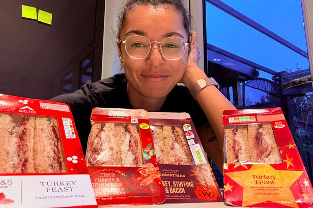 Author with Christmas sandwiches piled on table
