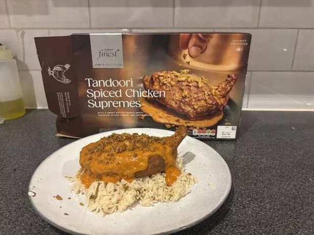 Plated chicken on a bed of rice