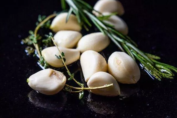 Sautéed garlic cloves cooked to perfection on a cast iron skillet, infusing a bold and flavorful taste to any dish. A versatile and essential ingredie