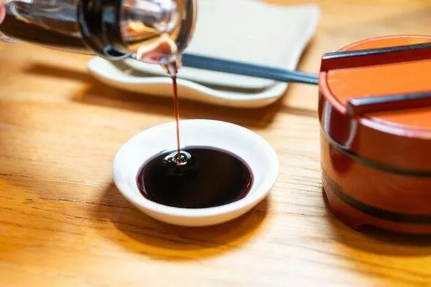 Soy Sauce Pouring into Dish