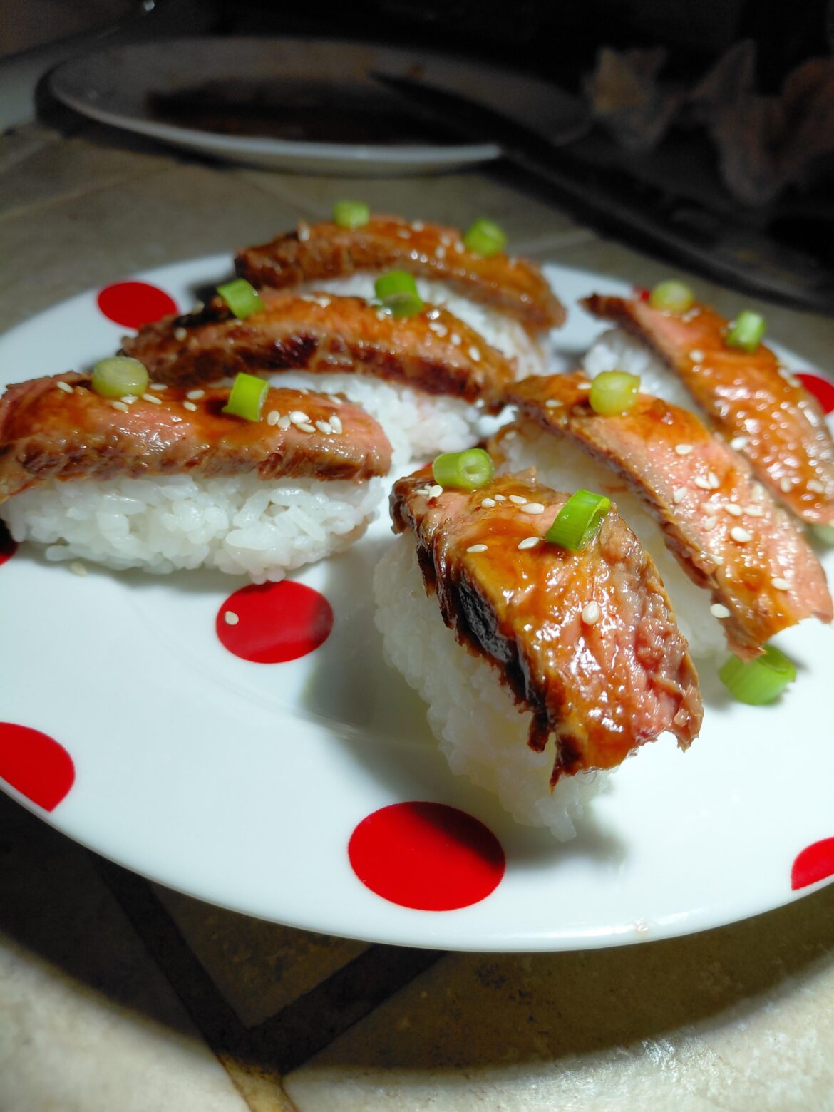 Someone suggested i post this here...ribeye nigiri at the house with Sriracha/soy sauce drizzle