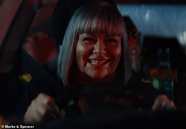 The 90-second films opens up on Christmas Eve and shows Dawn (pictured), 68, stuck in gridlocked traffic while singing Chris Rea's classic festive track Driving Home for Christmas