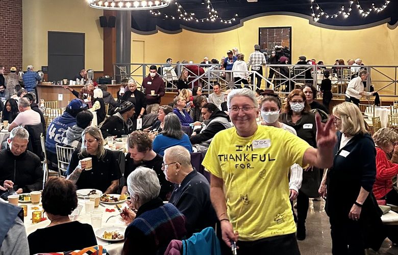 Community members gather during an annual Thanksgiving  meal at the Hall at Fauntleroy in West Seattle in 2023. Tuxedos & Tennis Shoes Catering provides the meal free of charge as part of a longstanding tradition of giving back to the community.
